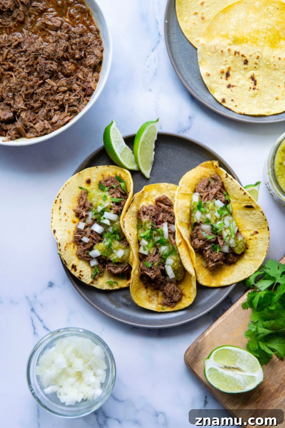 Instant Pot Barbacoa Beef Tacos with fall-apart-tender, spicy barbacoa beef and a sweet roasted pineapple tomatillo salsa.