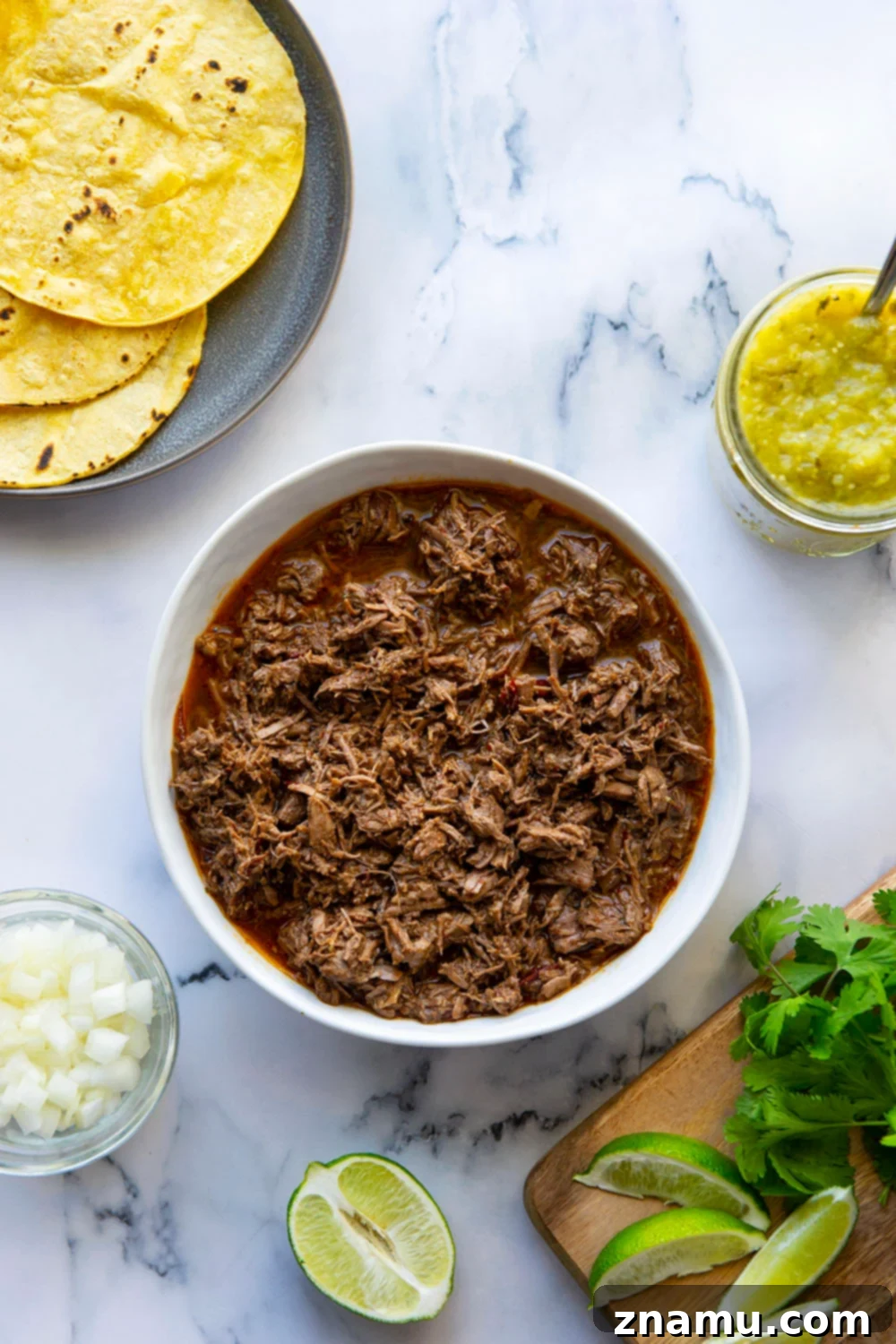 Instant Pot Barbacoa Beef Tacos featuring tender, shredded beef and a vibrant pineapple tomatillo salsa.