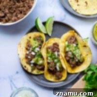 Instant Pot Barbacoa Beef Tacos with fall-apart-tender, spicy barbacoa beef and a sweet roasted pineapple tomatillo salsa.