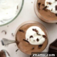 Rich and silky homemade chocolate pudding is easy to make from scratch and incredible with a scoop of fresh whipped cream and chocolate shavings on top.