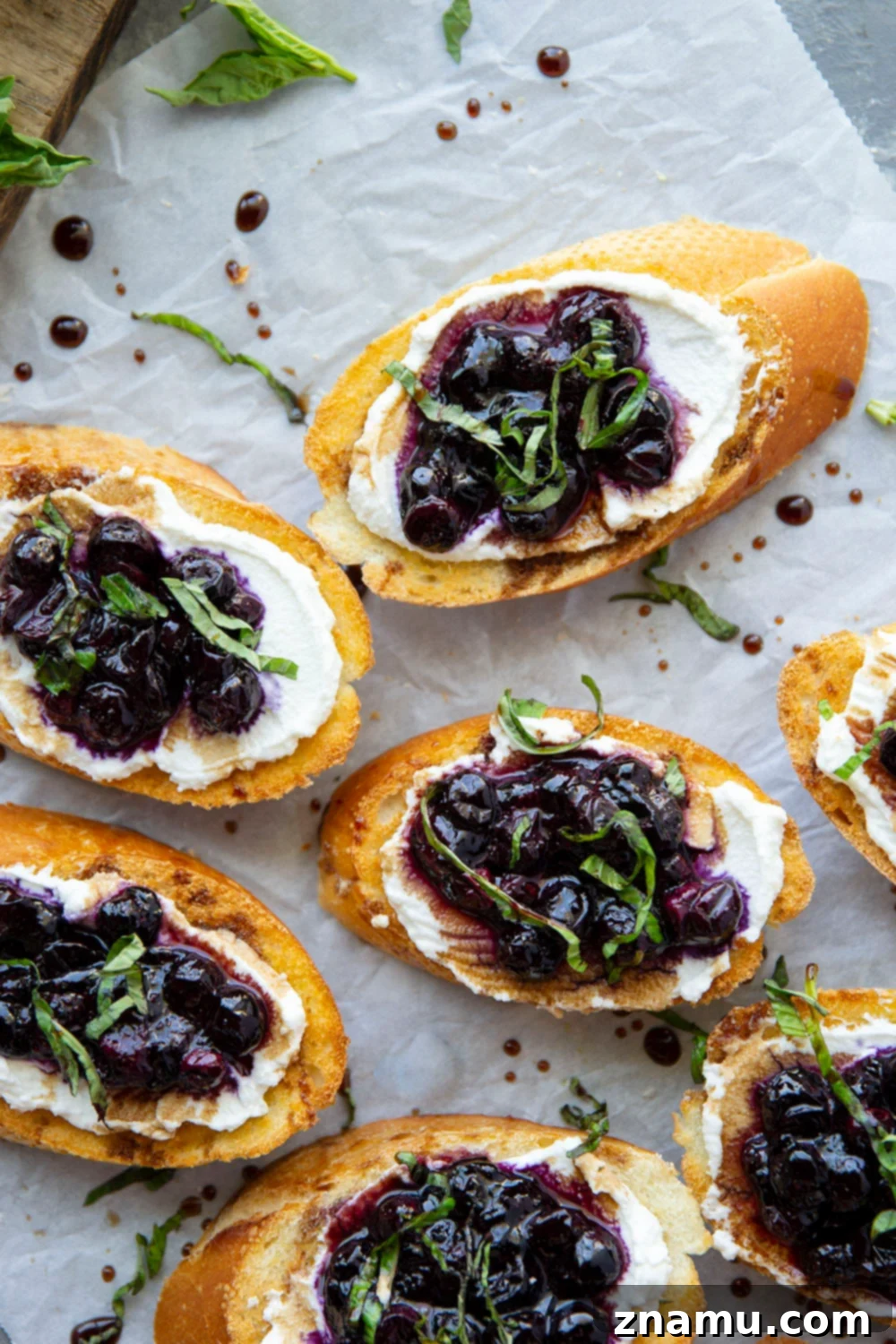 Blueberry Basil Ricotta Crostini 5 Roasting blueberries on a parchment-lined baking sheet
