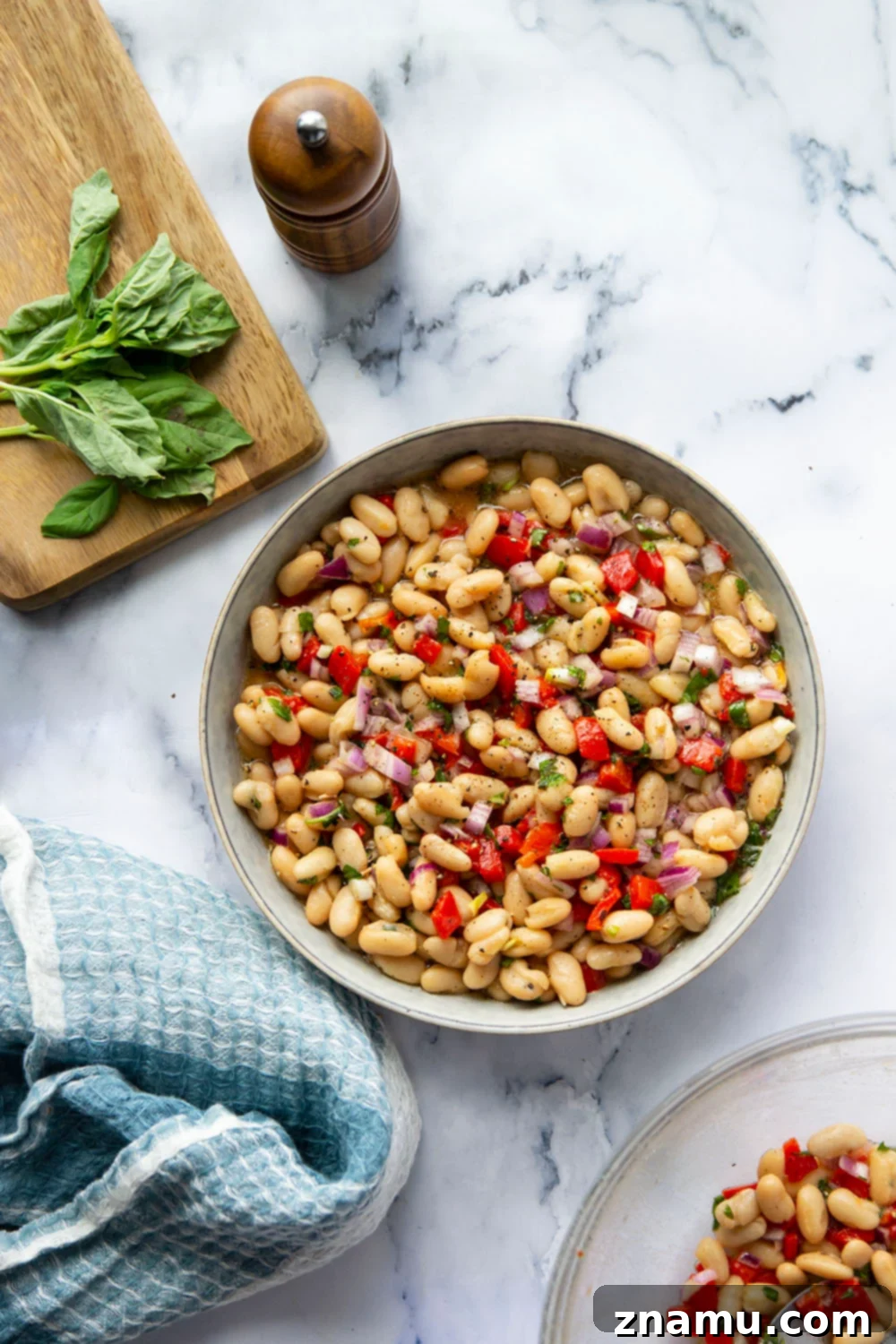 Miso Infused White Bean & Roasted Red Pepper Salad 5 Mixing bowl with white beans, roasted red peppers, and fresh herbs, ready for the miso dressing to be added and tossed.