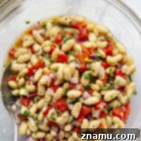 Loaded with tender white beans and roasted red peppers in a flavorful miso dressing, this white bean salad is the perfect salad side dish for any gathering!
