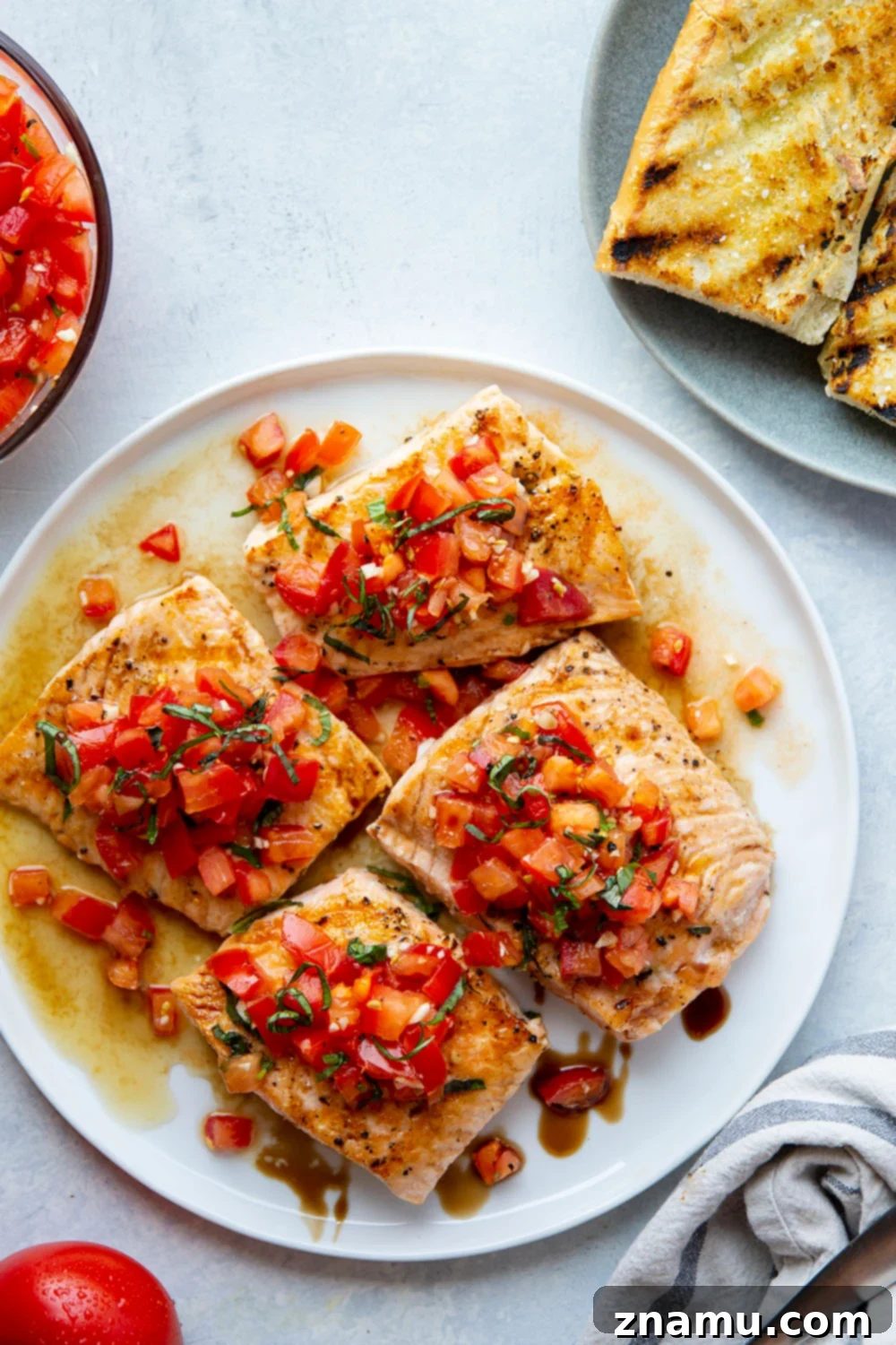 Grilled Bruschetta Salmon with Tomato Topping This grilled bruschetta salmon features perfectly grilled salmon fillets with a flavorful tomato bruschetta topping piled over top and lots of crusty grilled bread on the side.