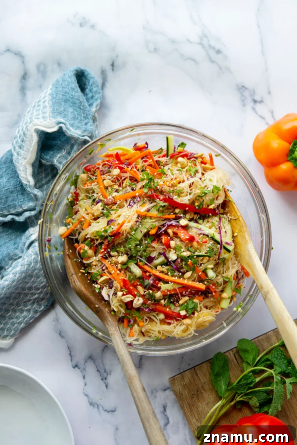 Vibrant Spring Roll Salad with Zesty Ginger Dressing 3 Close-up of the spring roll salad showcasing its beautiful colors, fresh herbs, and rice noodles, ready to be tossed in a spicy ginger dressing. Perfect for a healthy meal.