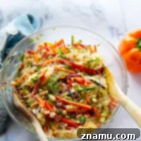 This loaded spring roll salad features a rainbow of fresh veggies and tender rice noodles tossed in a flavorful spicy ginger dressing. - it's so easy to make ahead of time for lunch or a side dish!