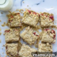 These raspberry rhubarb oatmeal bars feature a tangy fresh raspberry rhubarb filling with lots of buttery oatmeal streusel on top.