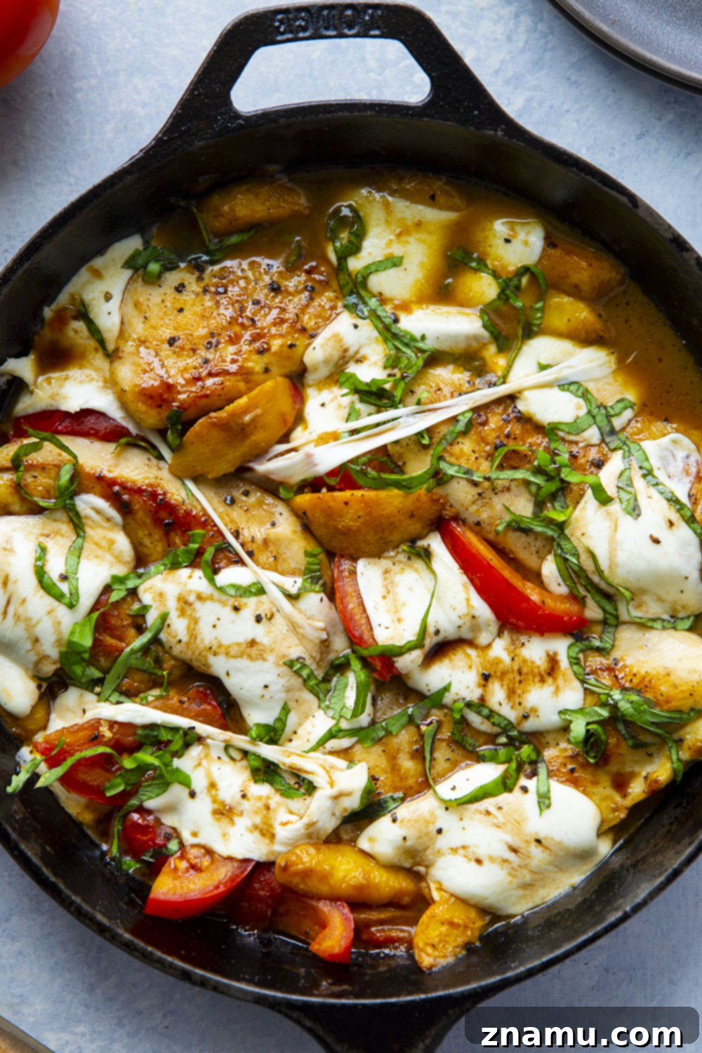 One-Pan Peach Caprese Chicken 6 Caprese Peach Chicken in a skillet, ready to be served, showcasing all the vibrant ingredients.