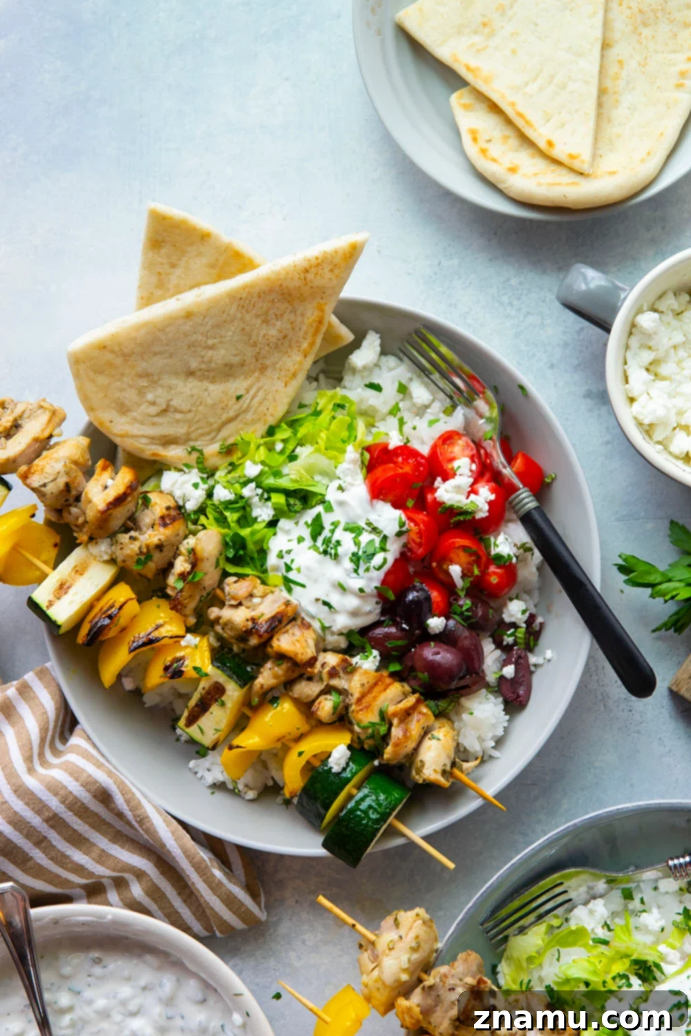 Zesty Grilled Chicken Souvlaki Bowls 2 These chicken souvlaki bowls feature flavorful grilled chicken and vegetable skewers in hearty rice bowls with homemade tzatziki sauce and lots of toppings.