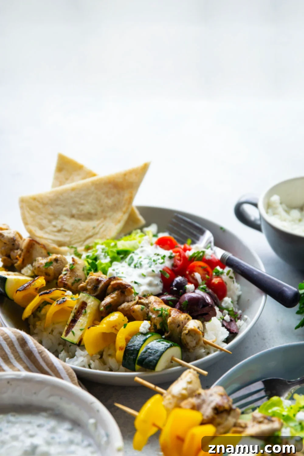 Zesty Grilled Chicken Souvlaki Bowls 4 These chicken souvlaki bowls feature flavorful grilled chicken and vegetable skewers in hearty rice bowls with homemade tzatziki sauce and lots of toppings.