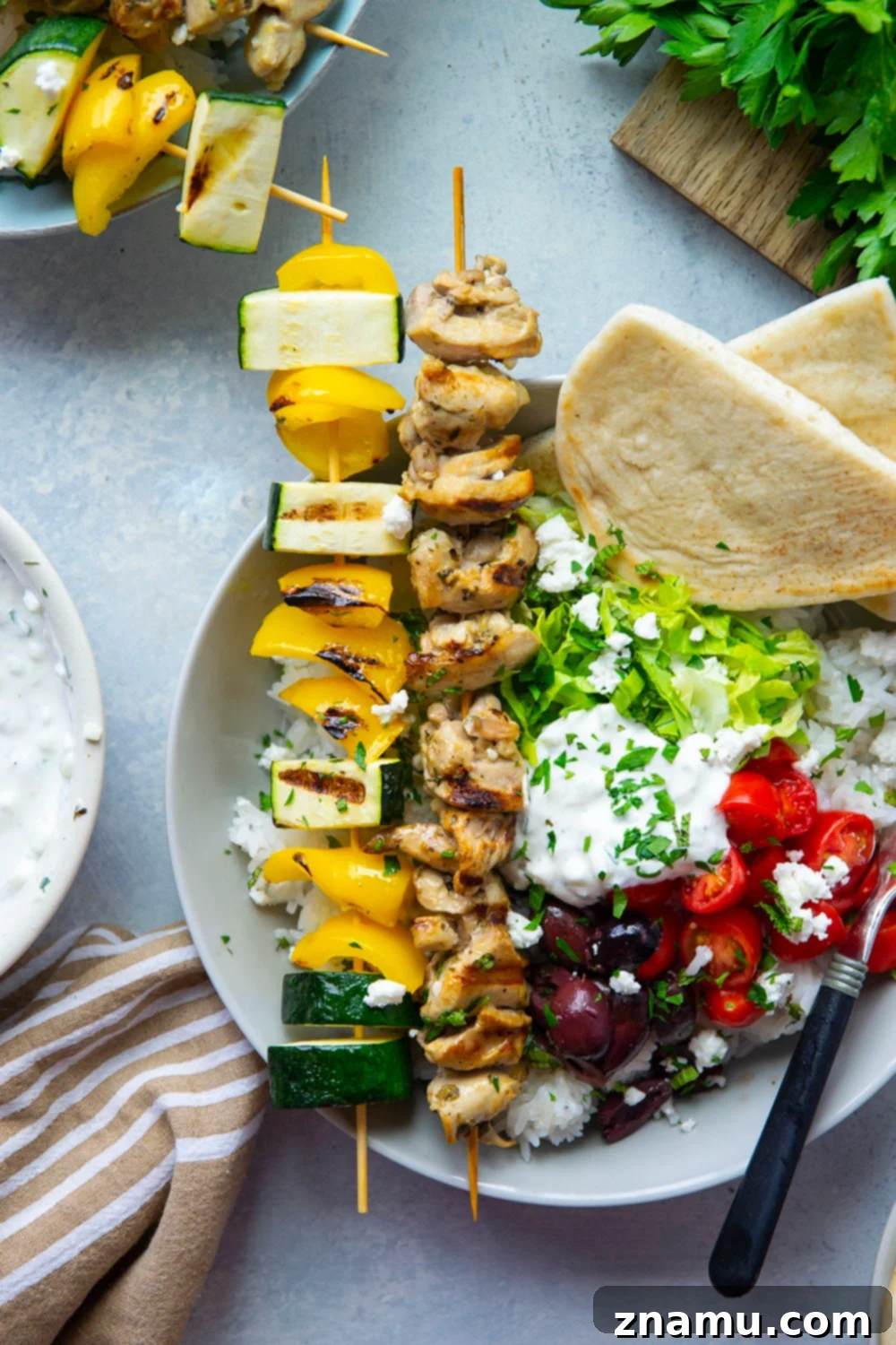 Zesty Grilled Chicken Souvlaki Bowls 5 These chicken souvlaki bowls feature flavorful grilled chicken and vegetable skewers in hearty rice bowls with homemade tzatziki sauce and lots of toppings.