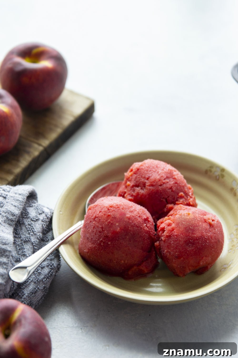 Refreshing Peach Cherry Sorbet 2 A vibrant bowl of homemade peach cherry sorbet, ready to be enjoyed. Made with fresh fruit, honey, lemon, and a touch of rum, this easy blender recipe is perfect for summer.
