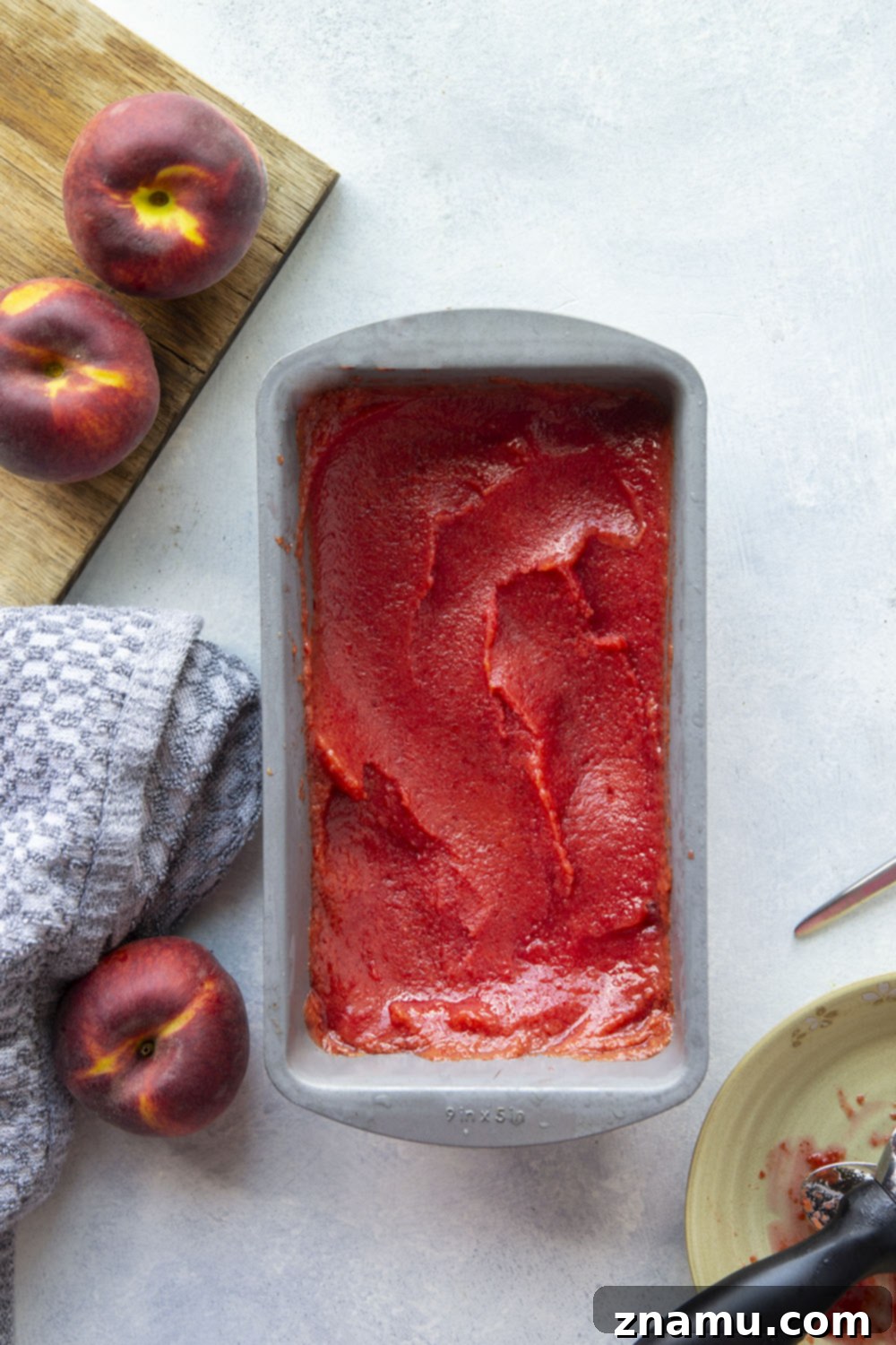 Refreshing Peach Cherry Sorbet 3 Close-up shot of creamy peach cherry sorbet in a glass bowl, showcasing its smooth texture and rich color. It's a healthy, low-calorie dessert perfect for hot days.