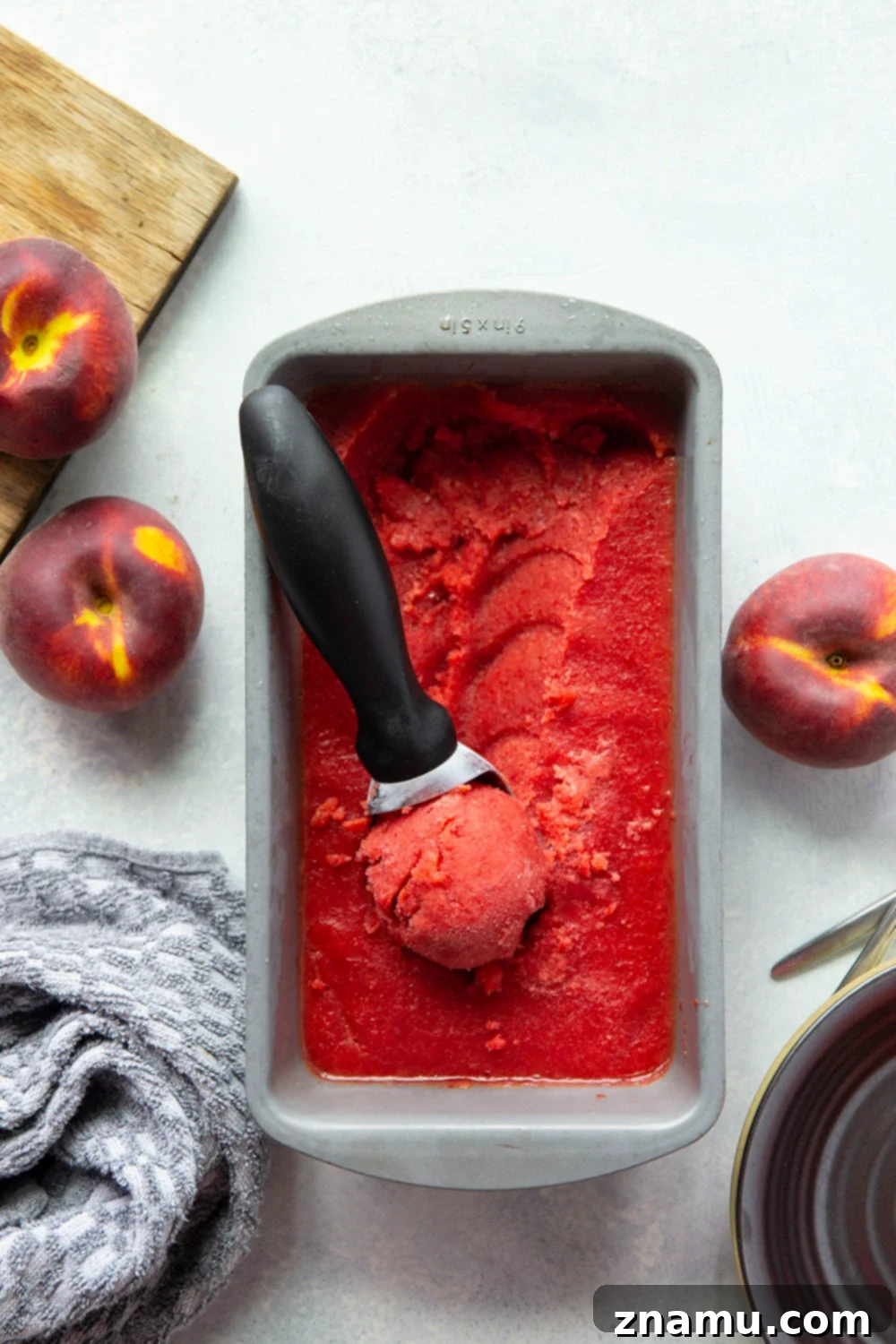 Refreshing Peach Cherry Sorbet 5 A high-speed blender processing frozen peaches, cherries, honey, and lemon juice into a smooth sorbet. Highlights the easy, no-churn method.