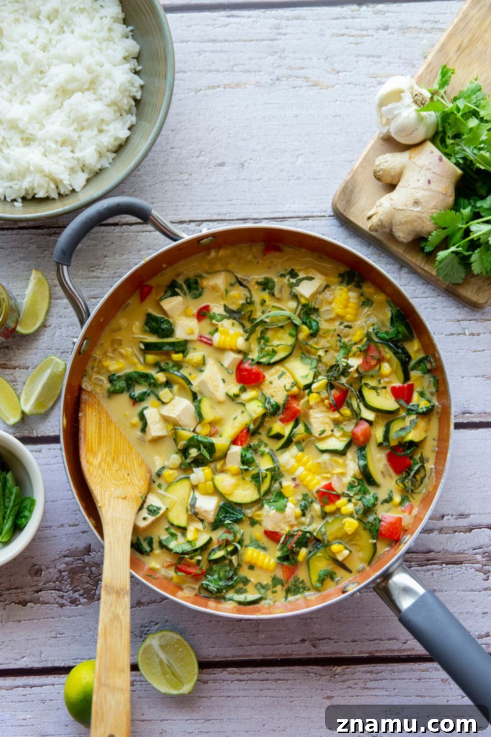 Close-up of a serving of Thai green curry tofu with rice, garnished with fresh cilantro.