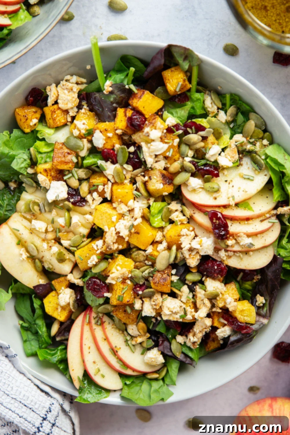 Maple Roasted Butternut Harvest Salad 5 Ingredients for a fall harvest salad including butternut squash, apples, pepitas, and a bottle of maple syrup.