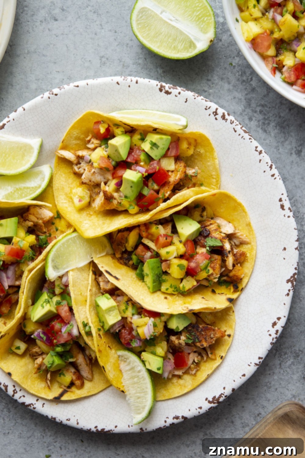 Smoky Salmon Tacos with Bright Pineapple Salsa 2 Blackened Salmon Tacos with Grilled Pineapple Salsa, featuring tender, flavorful salmon and a vibrant, smoky salsa on warm corn tortillas.