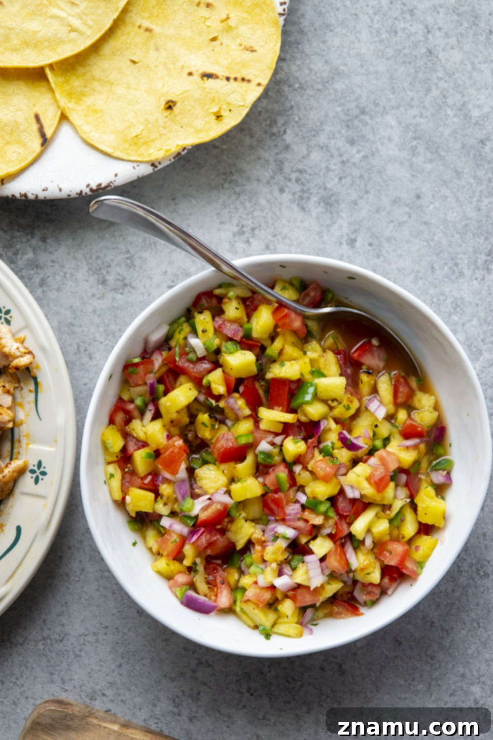 Smoky Salmon Tacos with Bright Pineapple Salsa 5 Delicious Blackened Salmon Tacos arranged on a platter with fresh lime wedges, ready to be served.