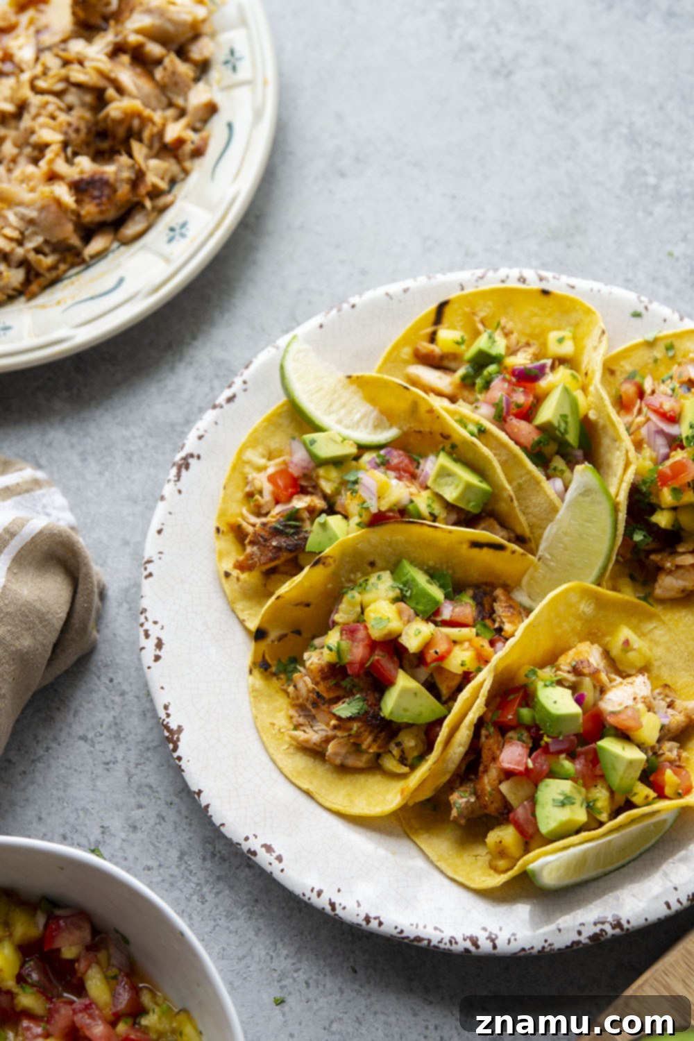 Smoky Salmon Tacos with Bright Pineapple Salsa 6 A vibrant platter of Blackened Salmon Tacos with Grilled Pineapple Salsa, garnished with fresh cilantro and lime, ready to serve.