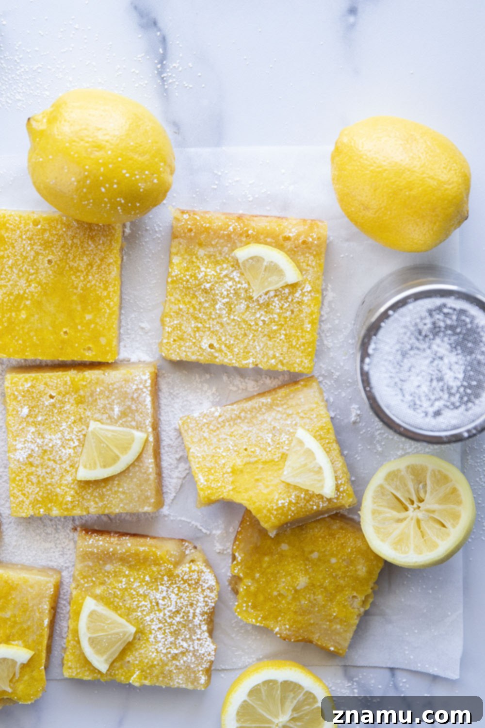 Perfect Lemon Bars 5 Ingredients for lemon bars laid out: fresh lemons, butter, sugar, flour, eggs, and vanilla extract.