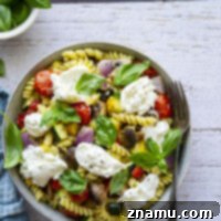 This roasted vegetable pasta features a rainbow of tender roasted summer vegetables tossed with pasta and topped with lots of fresh basil and burrata cheese.