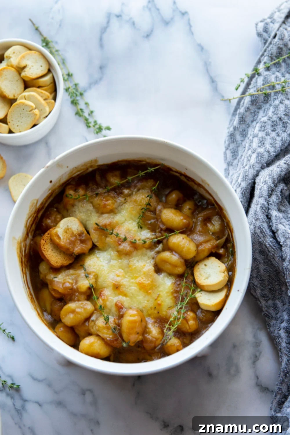 Savory Onion Gnocchi Gratin 6 This baked French onion gnocchi is like a heartier version of the classic soup! Tender gnocchi is baked in a flavorful caramelized onion beef broth with lots of rich cheese on top and French bread slices for dipping.