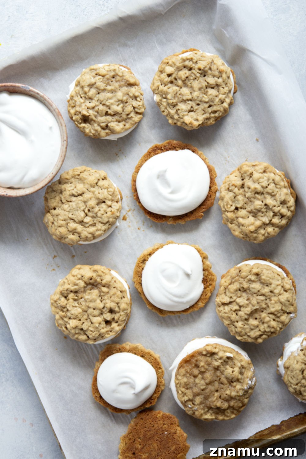 Homemade Oatmeal Creamy Delights 4 Three homemade oatmeal cream pies, stacked on a white plate