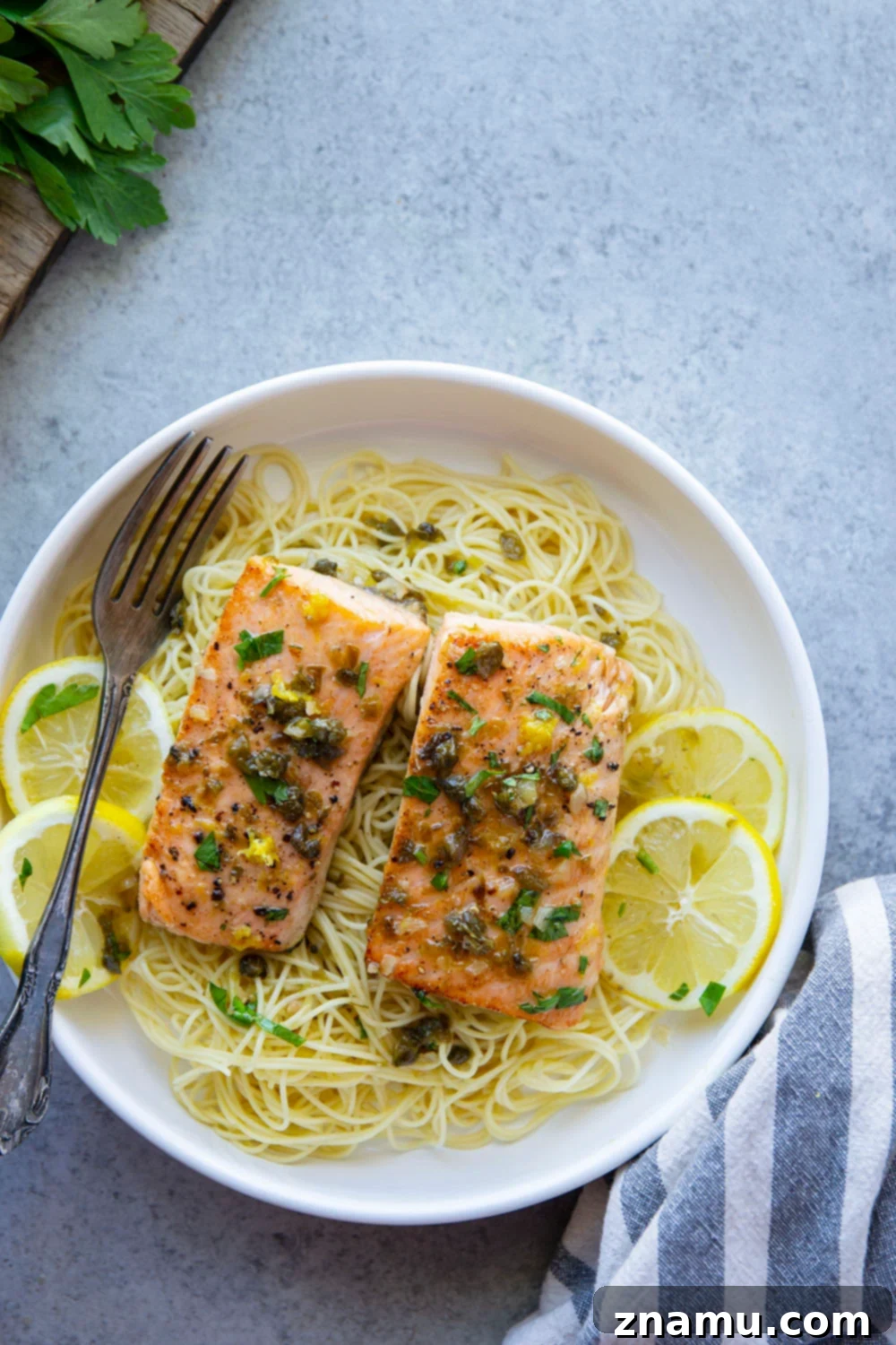 Weeknight Salmon Piccata Skillet 6 A bowl of One Pan Salmon Piccata with angel hair pasta.