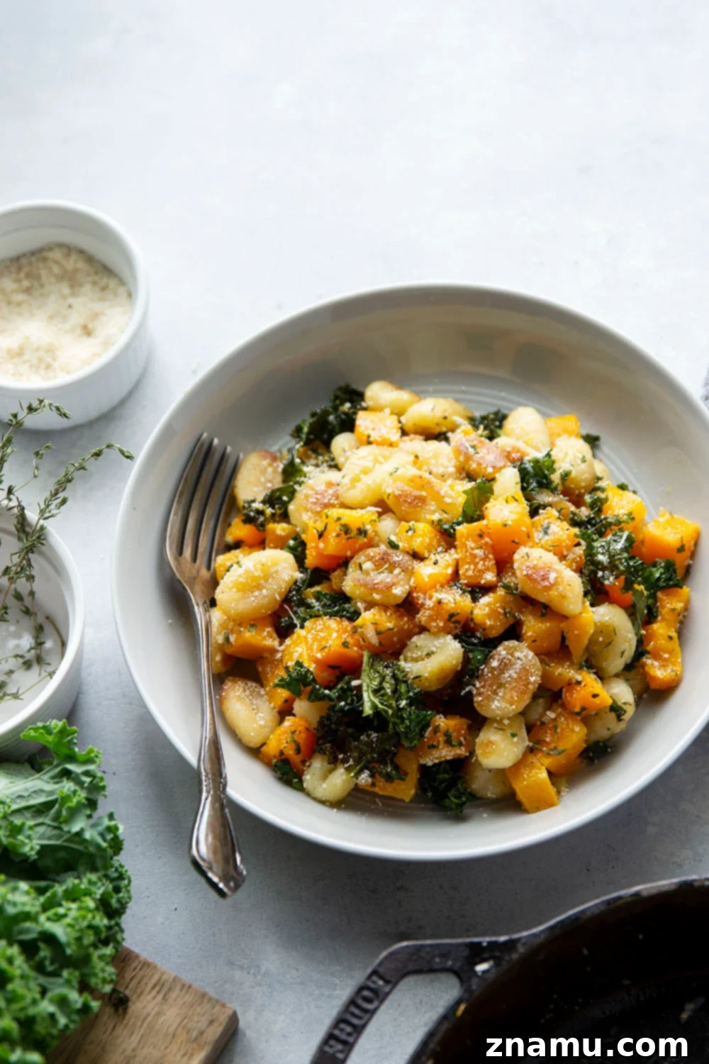 Roasted Butternut Garlic Gnocchi 3 Close-up of crispy pan-fried gnocchi, roasted butternut squash, kale, and garlic in a skillet.