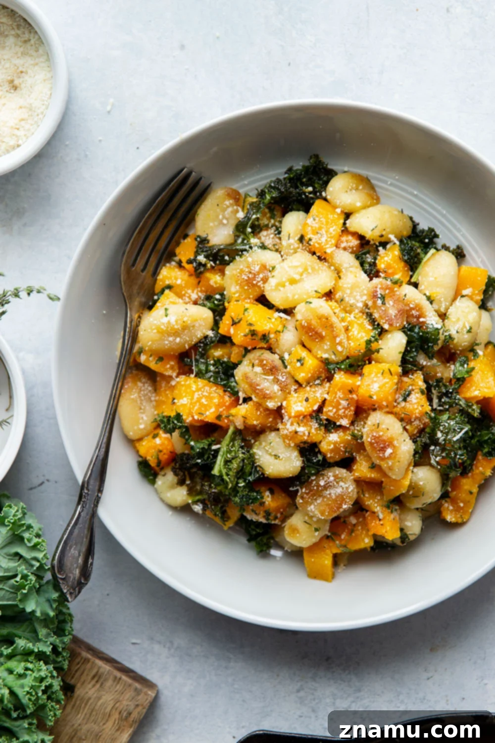 Roasted Butternut Garlic Gnocchi 6 Butternut squash and gnocchi skillet served in a bowl, topped with fresh Parmesan.