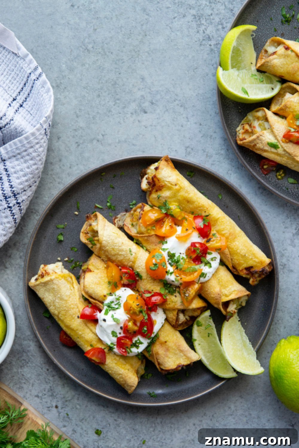 Close-up of golden brown air fryer chicken taquitos with creamy green chile filling