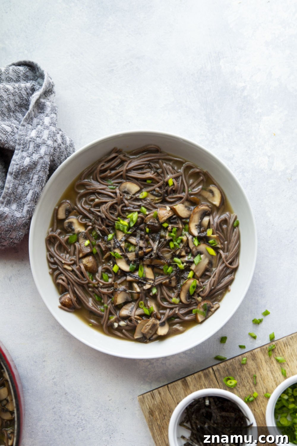 Soulful Miso Mushroom Noodles 5 Assortment of fresh mushrooms on a cutting board, ready for slicing.