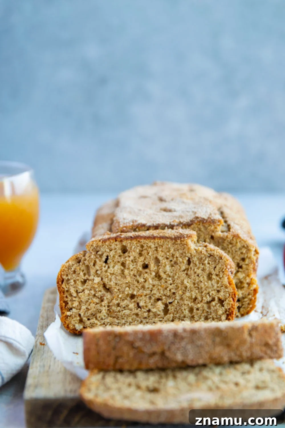 Autumn Orchard Donut Loaf 6 Close-up of a perfectly baked, golden-brown Apple Cider Donut Bread slice, ready to be enjoyed