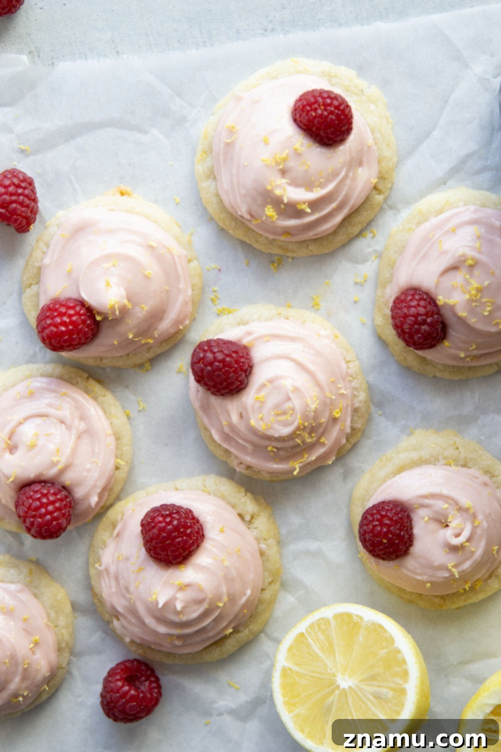 Delightful pink-frosted lemon shortbread cookies on a white plate, ready for spring celebrations