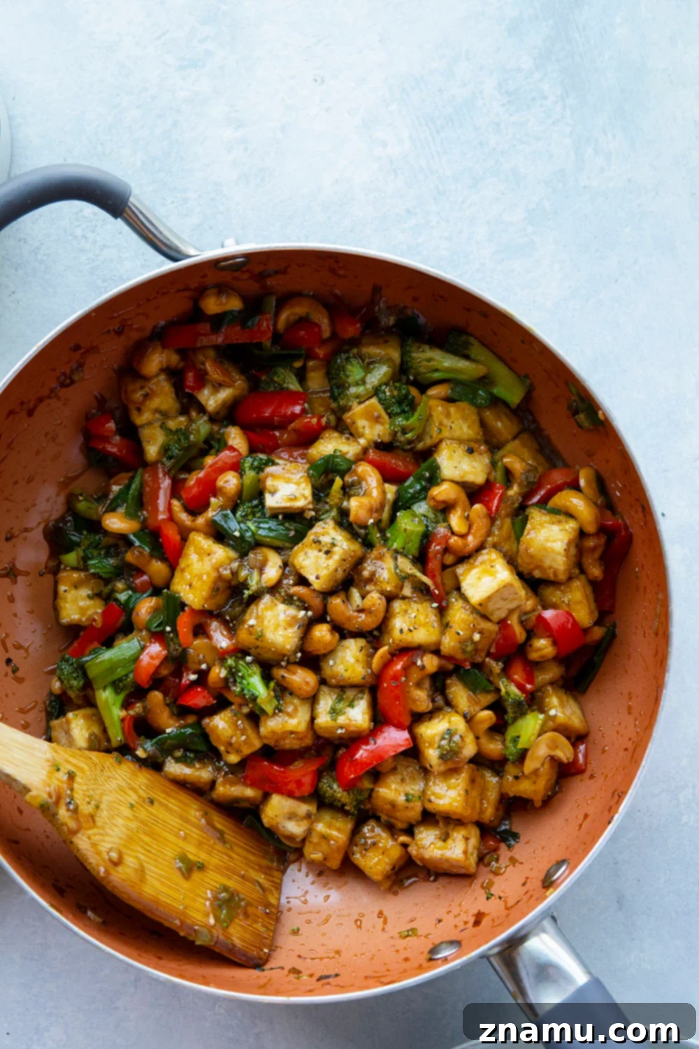 Wok-Kissed Cashew Tofu 3 Close-up shot of pan-fried tofu cubes with a crispy golden exterior, ready to be added to a stir fry.