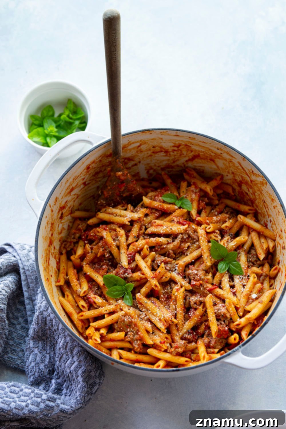 Smoky Red Pepper & Sausage Vodka Pasta 3 A large pot filled with Penne alla Vodka with Sausage, garnished with fresh basil, ready to be served, highlighting the vibrant colors and creamy texture.