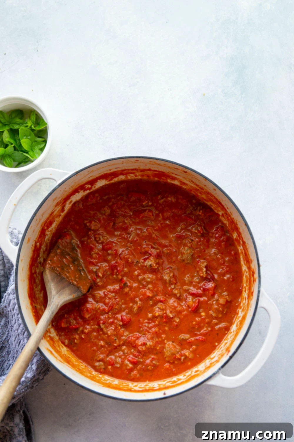 Smoky Red Pepper & Sausage Vodka Pasta 4 A close-up of browned Italian sausage sizzling in a Dutch oven, an essential first step for this flavorful pasta dish.