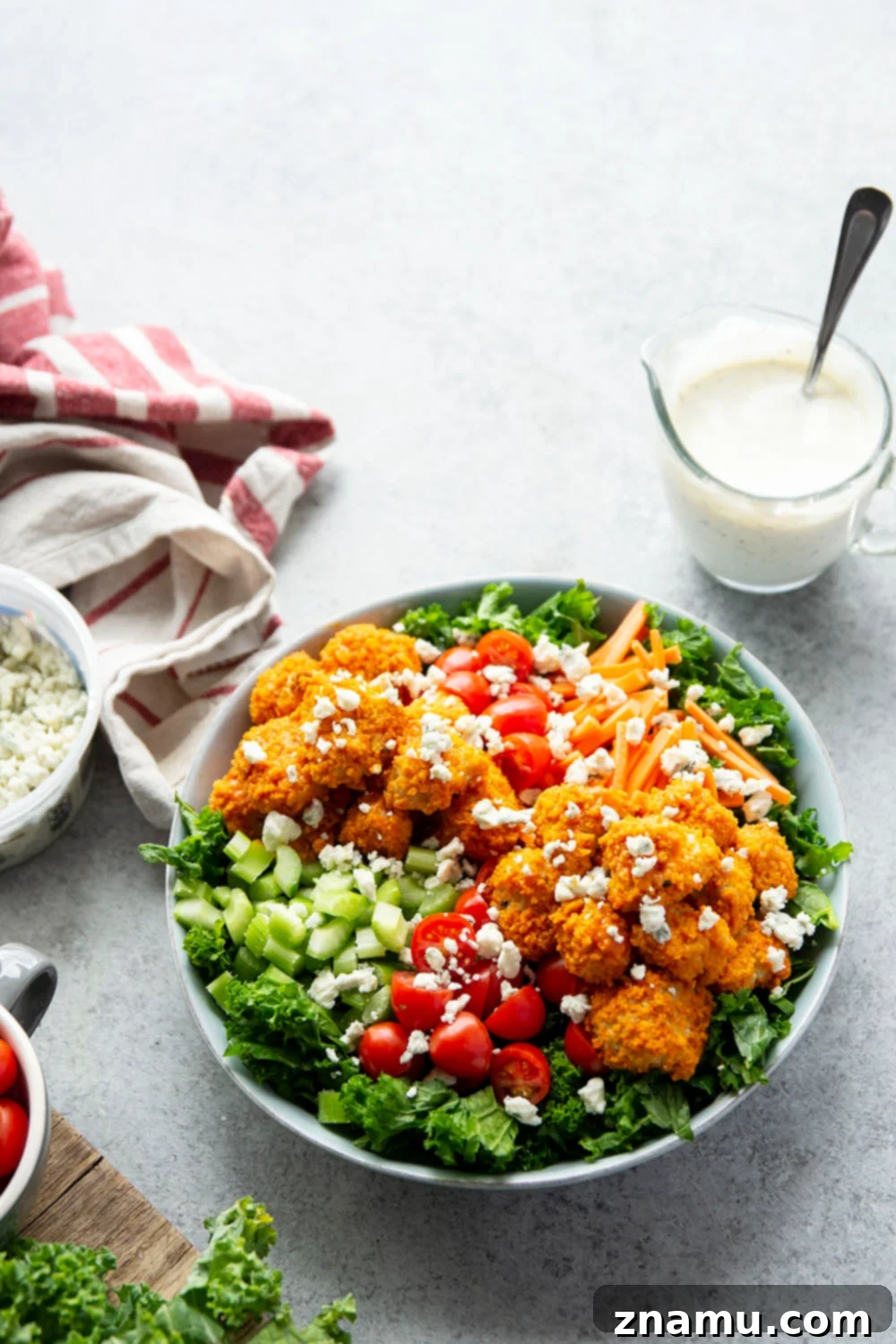 Fiery Buffalo Chicken Kale Delight 5 Ingredients for buffalo chicken kale salad, including air-fried chicken, kale, ranch dressing, and blue cheese.