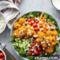 Fiery Buffalo Chicken Kale Delight 8 This buffalo chicken kale salad features crispy buffalo chicken pieces tossed with tender kale and fresh vegetables and topped with a creamy buttermilk ranch dressing and plenty of blue cheese.