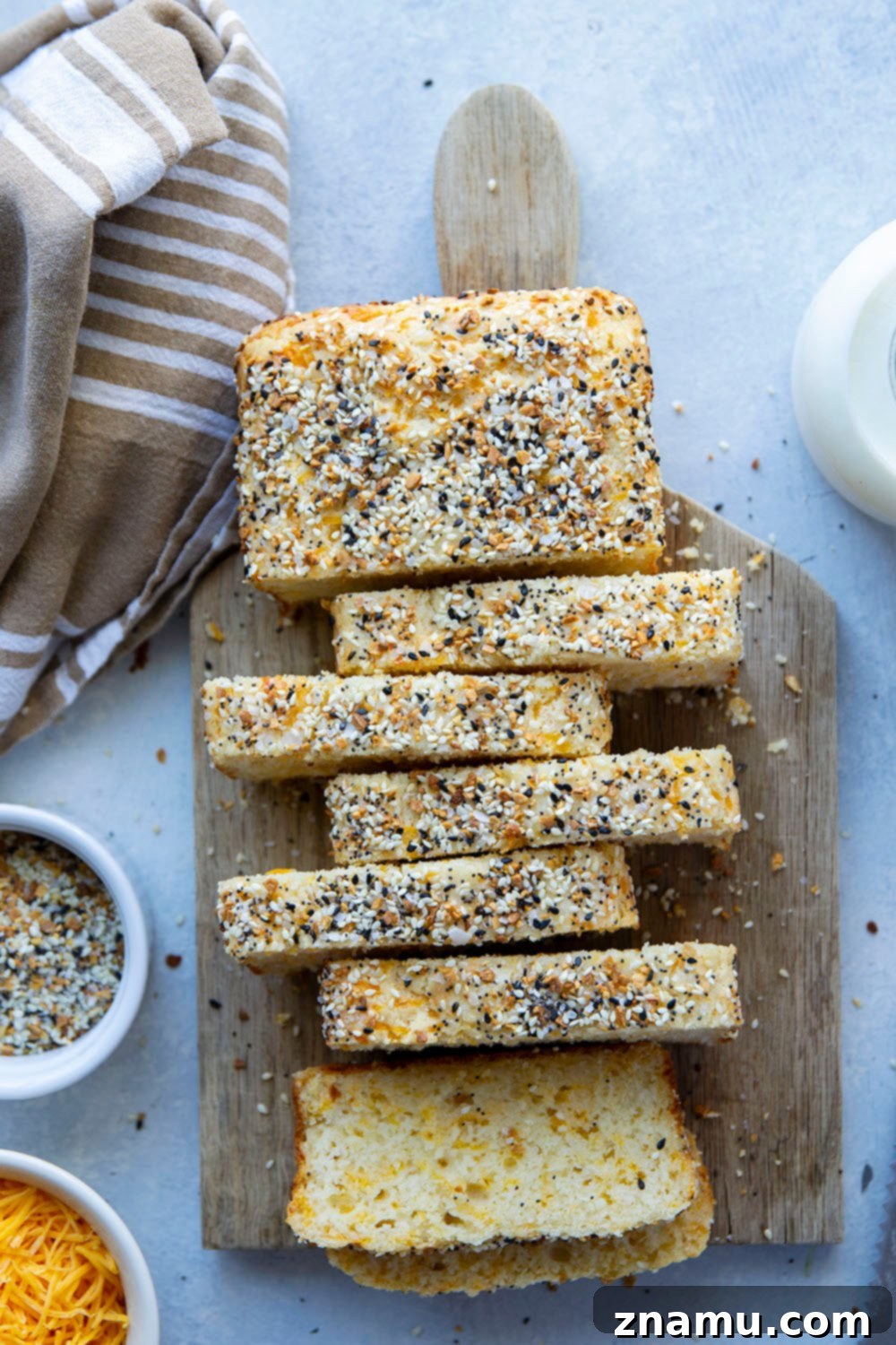 Everything Bagel Cheesy Loaf 4 Overhead shot of a full loaf of Everything Bagel Quick Bread, garnished with generous amounts of everything bagel seasoning.