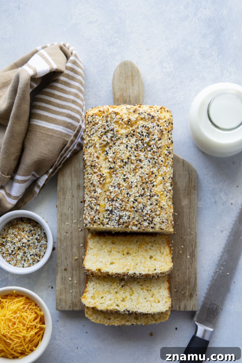 Everything Bagel Cheesy Loaf 5 Ingredients laid out for Cheesy Everything Bagel Quick Bread, including cheeses, flour, and everything bagel seasoning.