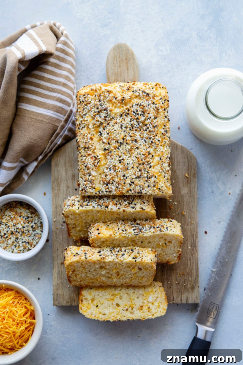 Everything Bagel Cheesy Loaf 6 Warm slice of Cheesy Everything Bagel Quick Bread on a wooden board, ready to be served.