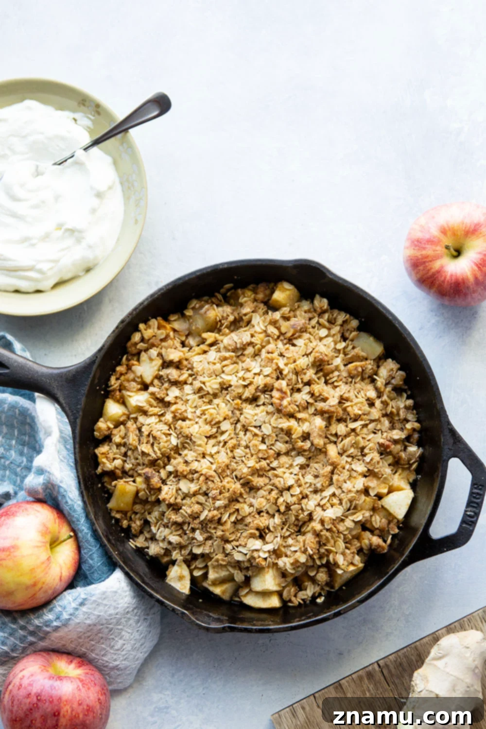 Zingy Ginger Apple Skillet Crisp 4 A serving of Ginger Apple Crisp with a spoon, showcasing the tender apples and crunchy streusel topping.
