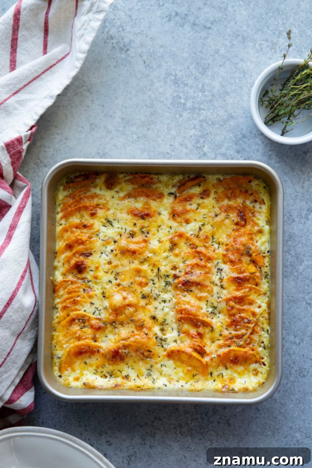 Golden Three-Cheese Sweet Potato Gratin 3 This sweet potato au gratin features tender sweet potatoes in a rich cream sauce with lots of gouda, gruyere, and Parmesan cheese baked on top.