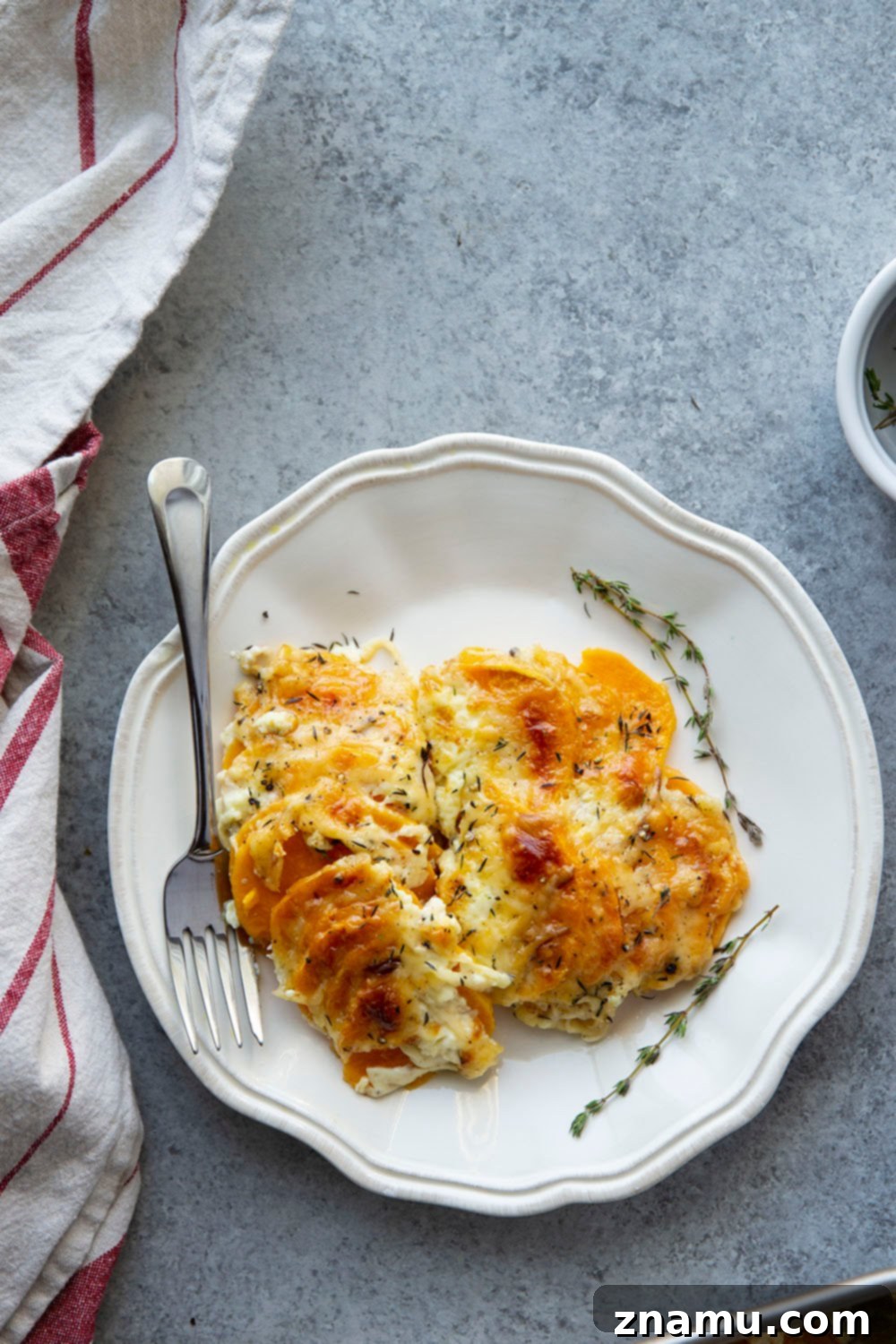 Golden Three-Cheese Sweet Potato Gratin 4 This sweet potato au gratin features tender sweet potatoes in a rich cream sauce with lots of gouda, gruyere, and Parmesan cheese baked on top.