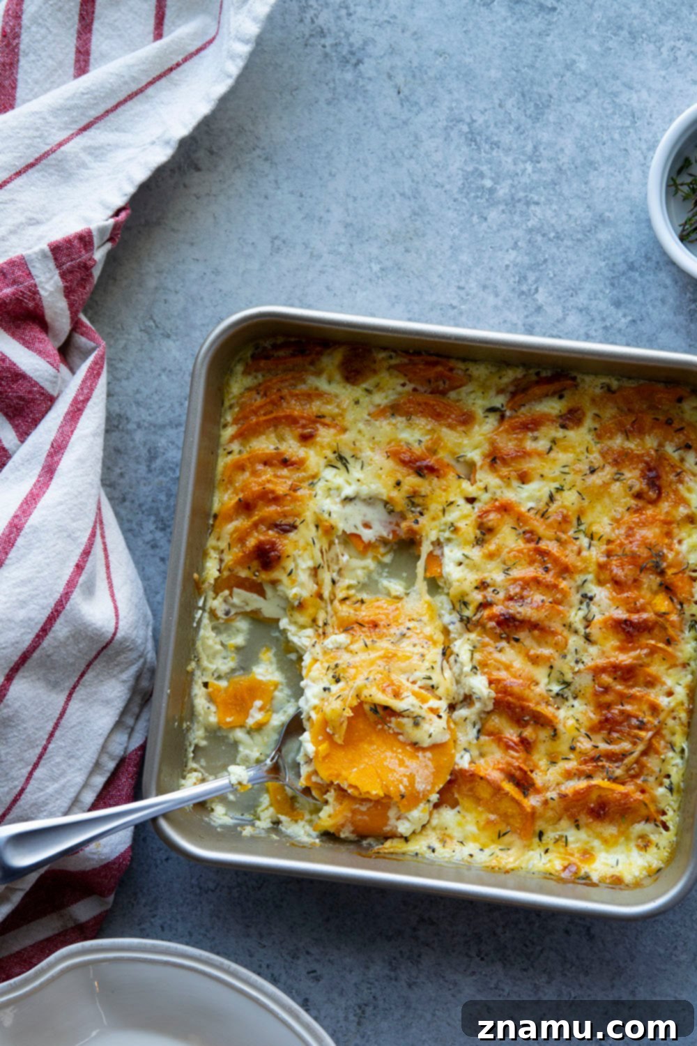 Golden Three-Cheese Sweet Potato Gratin 5 This sweet potato au gratin features tender sweet potatoes in a rich cream sauce with lots of gouda, gruyere, and Parmesan cheese baked on top.