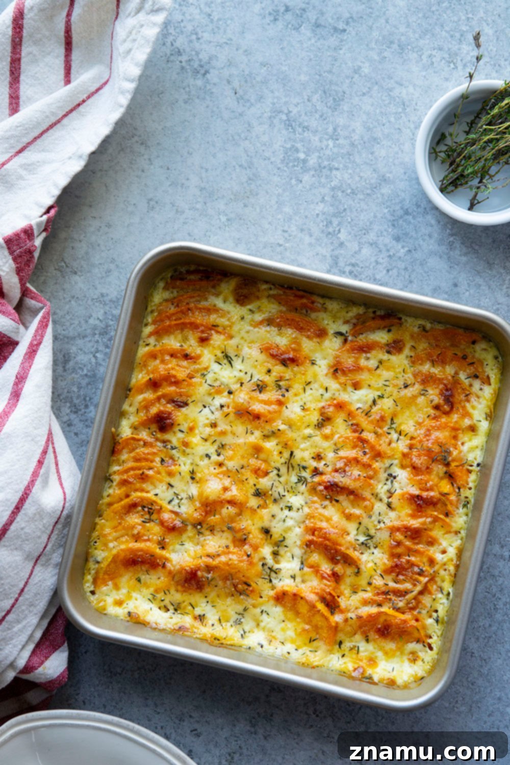 Golden Three-Cheese Sweet Potato Gratin 6 This sweet potato au gratin features tender sweet potatoes in a rich cream sauce with lots of gouda, gruyere, and Parmesan cheese baked on top.