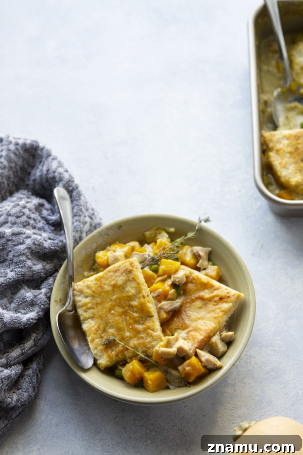 Comforting Turkey Butternut Squash Pot Pie 4 Turkey and butternut squash pot pie filling with fresh herbs before being topped with pastry.