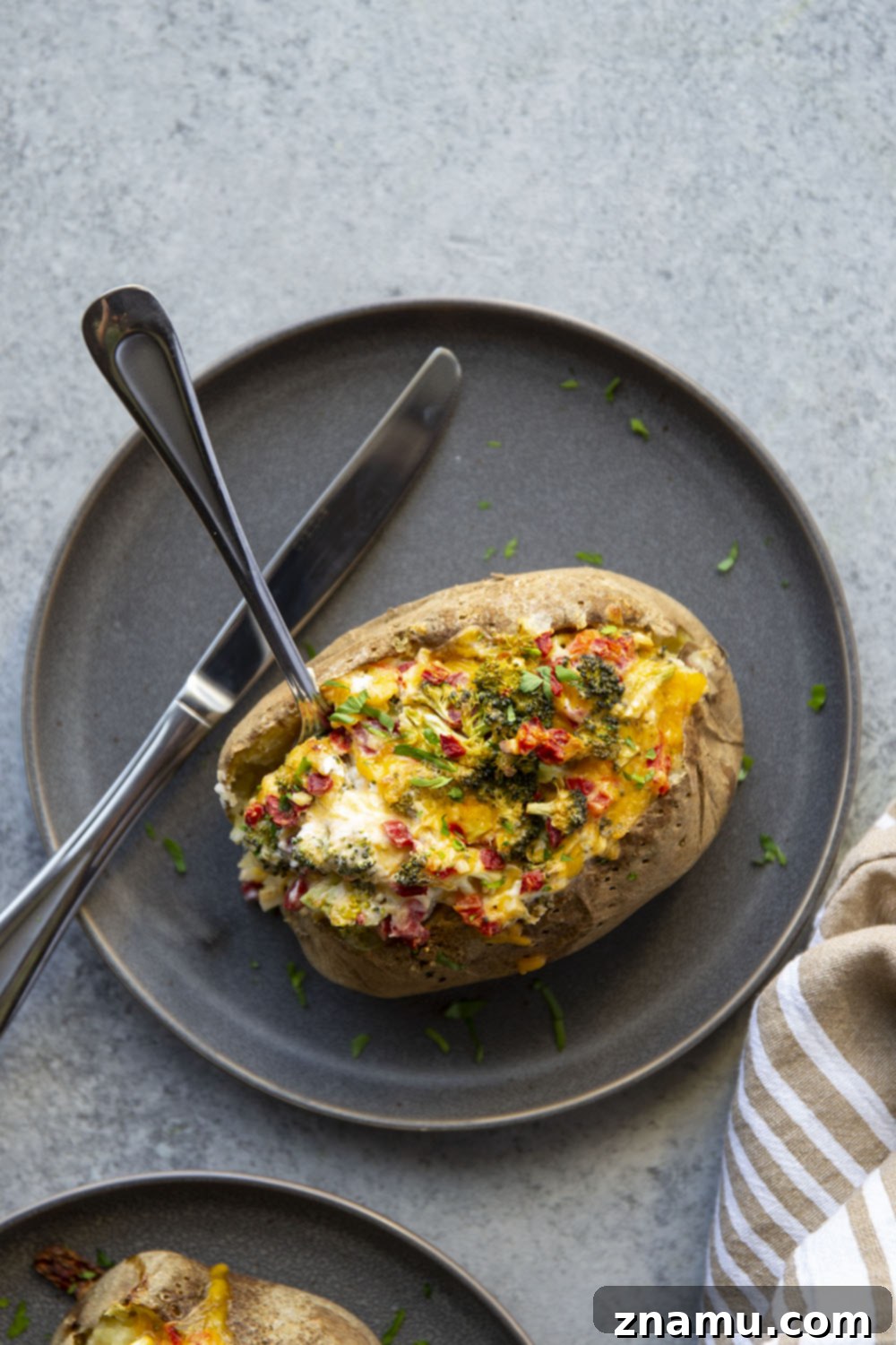 Loaded Broccoli Cheddar Potatoes 6 Perfectly golden and bubbly Broccoli Cheddar Baked Potatoes, garnished with fresh parsley.