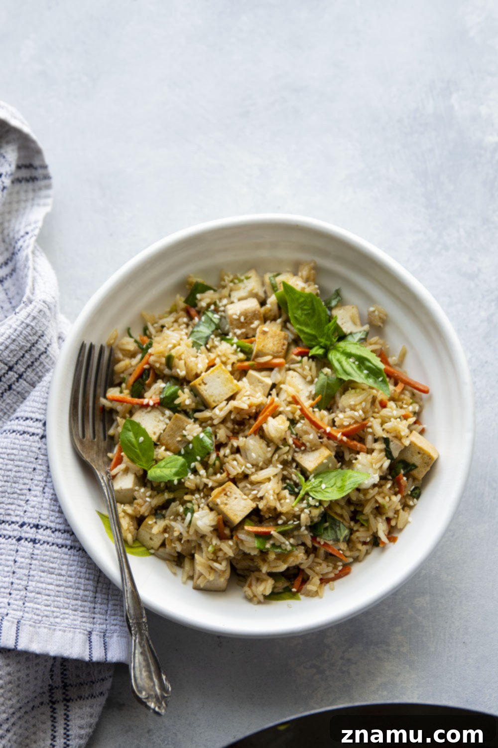 Crispy Sesame Tofu with Aromatic Thai Basil Fried Rice 2 This Thai basil fried rice features the most flavorful basil fried rice with lots of crispy sesame marinated tofu. - it's so easy to make in minutes using leftover cooked rice!